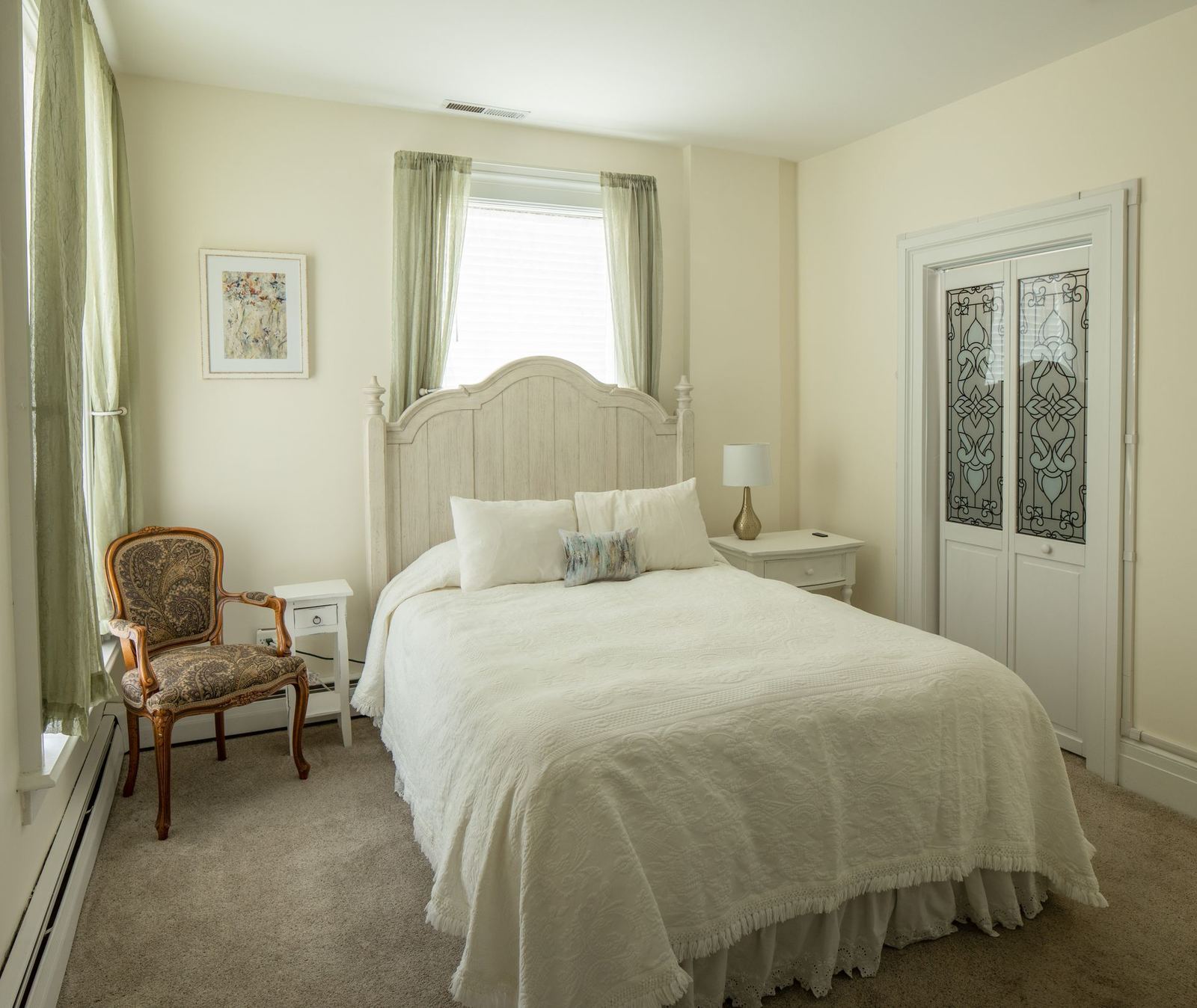 Ann's room with queen bed and stained glass doors