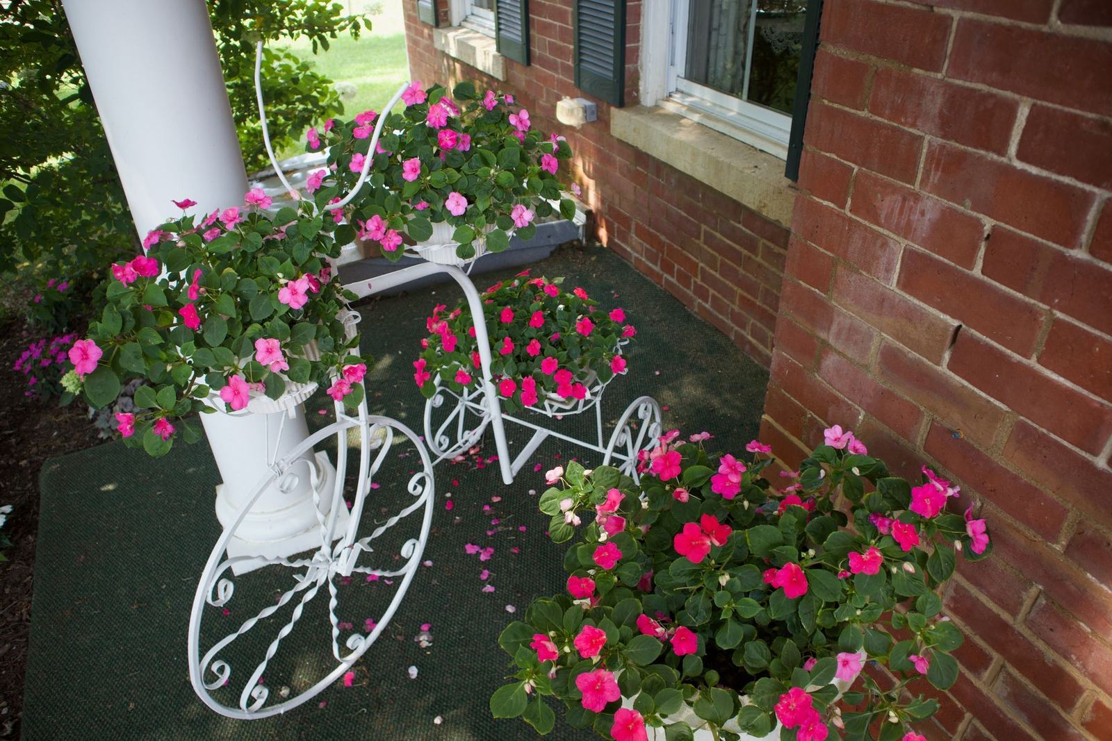 Flowers by the brick wall of the mansion porch