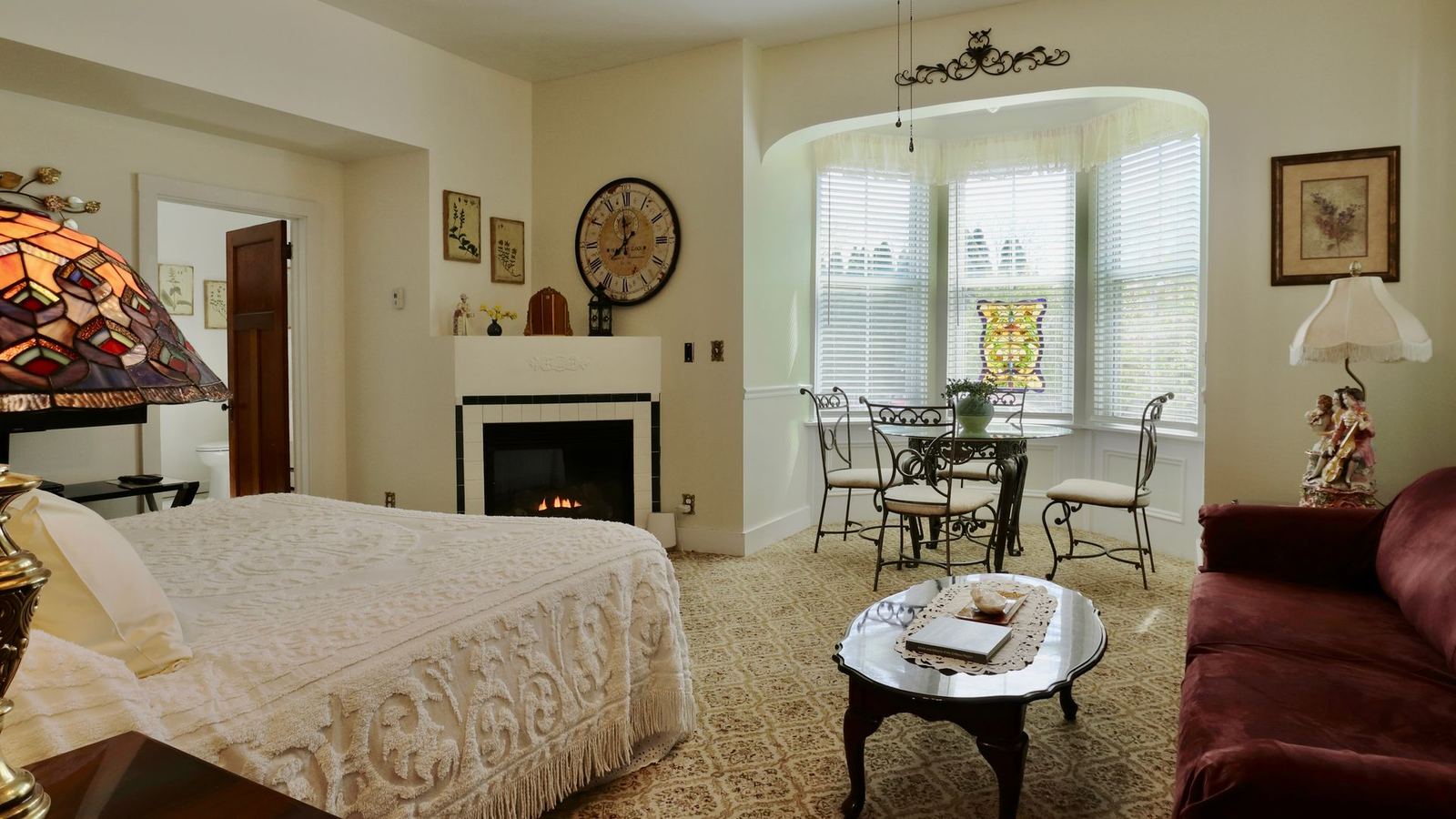 Sara's room with fireplace, bay window seating and sofa