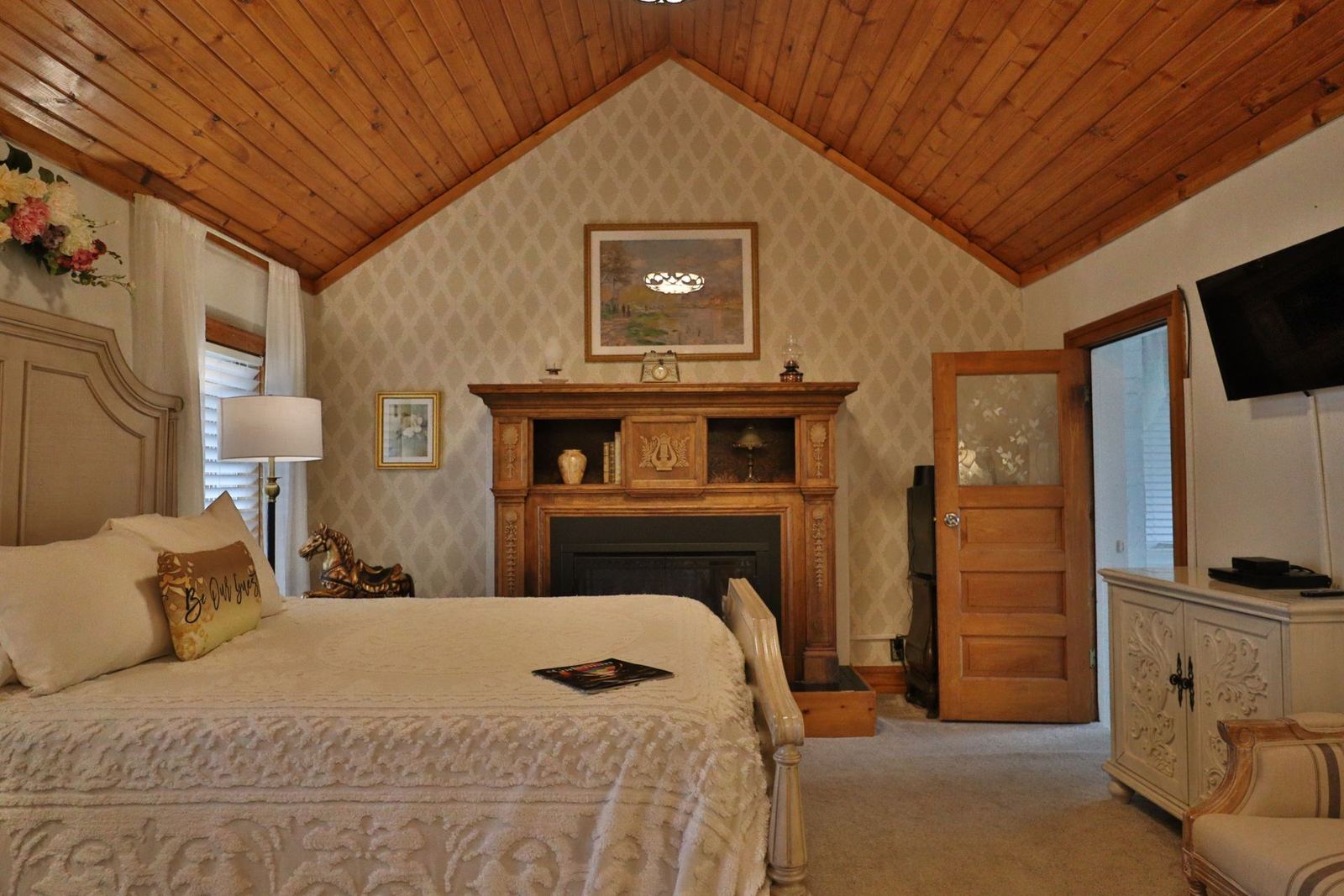 Tower Room bedroom with fireplace and wood cathedral ceiling